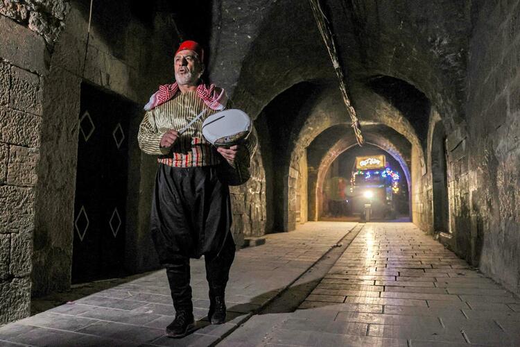 In Pictures: Volunteers and a 'Musaharati' Deliver Pre-Dawn Meals in Syria