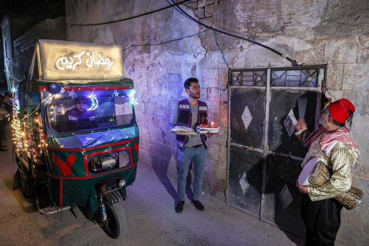 In Pictures: Volunteers and a 'Musaharati' Deliver Pre-Dawn Meals in Syria