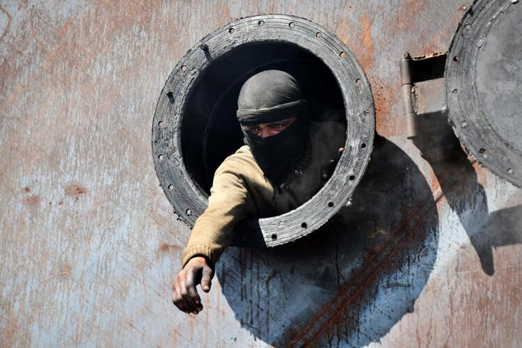 In Pictures: Syrian Children Work at Oil Refinery to Get By