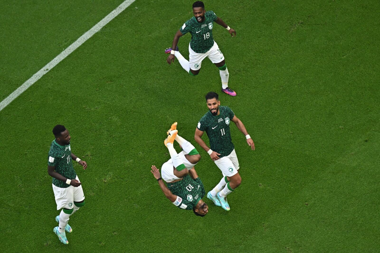 Saudi Arabia's midfielder #10 Salem Al-Dawsari celebrates with his teammates after scoring the second goal during the Qatar 2022 World Cup Group C football match between Argentina and Saudi Arabia at the Lusail Stadium in Lusail, north of Doha on November 22, 2022. (Photo by Glyn KIRK / AFP)
