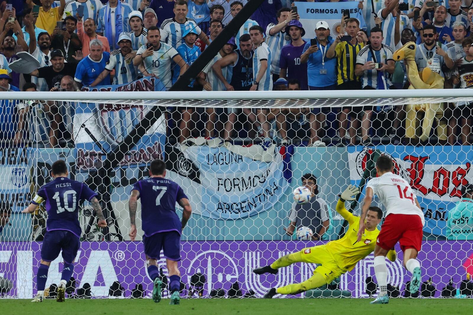 Poland's goalkeeper #01 Wojciech Szczesny (in yellow) saves the penalty shot by Argentina's forward #10 Lionel Messi (L) during the Qatar 2022 World Cup Group C football match between Poland and Argentina at Stadium 974 in Doha on November 30, 2022. (Photo by Giuseppe CACACE / AFP)