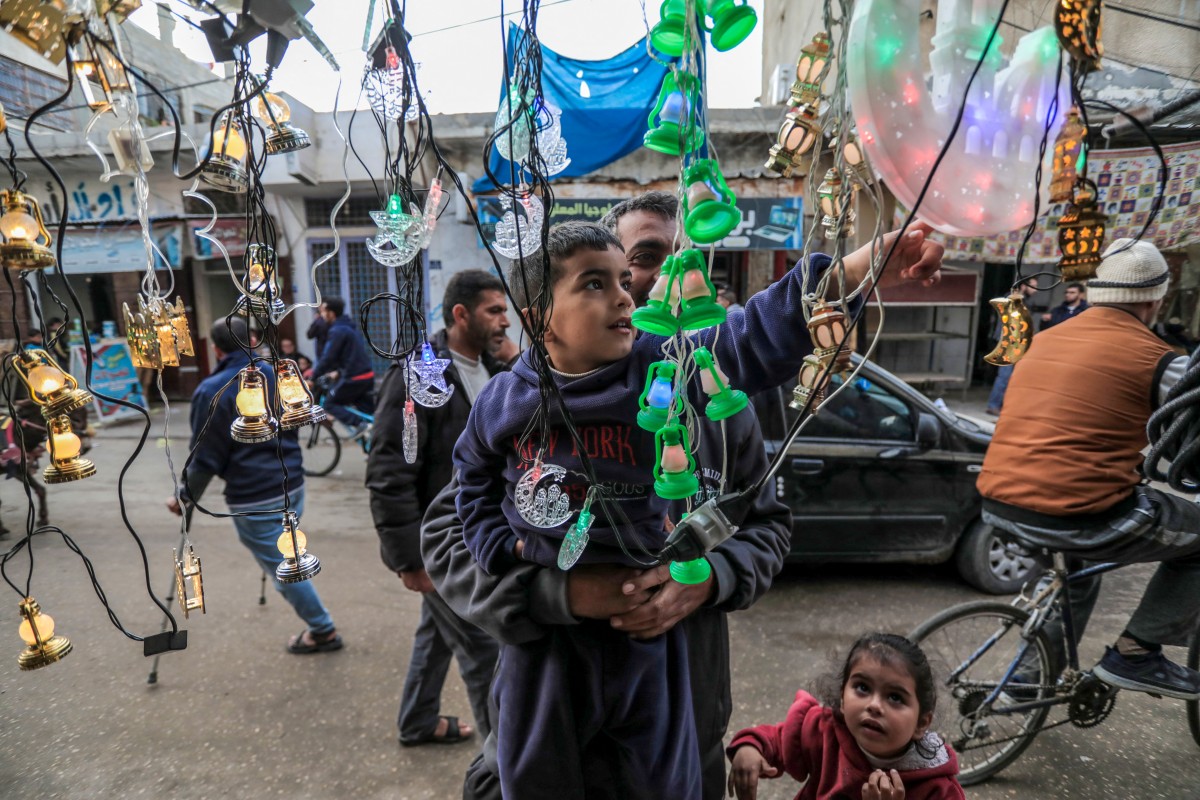 People shop for decorative lights and lanterns in Deir al-Balah in central Gaza, as Muslims prepare for the holy fasting month of Ramadan on March 3, 2024, amid the ongoing battles between Israel and the Palestinian militant group Hamas. For Muslims across the world, the beginning of the ninth month in the Muslim lunar calendar which marks the start of Ramadan, is a time for spiritual reflection, prayers, fasting and family reunions around the table after breaking the fast. (Photo by AFP)