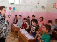 Antoinette Makh, instructs her pupils in the Aramaic language at a school in the Syrian mountain village of Maalula, in the Damascus region on May 13, 2019. LOUAI BESHARA / AFP