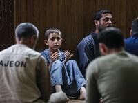 A young boy prays with other Muslim worshippers at a mosque in Maaret al-Noman in Syria's northwestern Idlib province early on June 1, 2019, on the occasion of Lailat al-Qadr, which marks the night in the fasting month of Ramadan during which the Koran was first revealed to Prophet Mohammed in the seventh century.  OMAR HAJ KADOUR / AFP