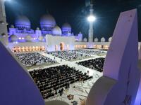 This picture taken early on June 1, 2019 from the crenellations of the Sheikh Zayed Grand Mosque in the UAE capital Abu Dhabi shows Muslim worshippers praying in the mosque's courtyard on the occasion of Lailat al-Qadr. KARIM SAHIB / AFP