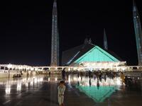 A child joins Pakistani Muslim worshippers and they gather at the illuminated Grand Faisal Mosque on the 27th night of the Holy month of Ramadan, in Islamabad on June 1, 2019.  The 27th night is known as Lailat al-Qader. FAROOQ NAEEM / AFP