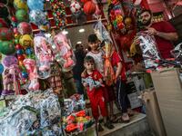 A Palestinian vendor sells toys at a market ahead of Eid al-Fitr holiday, celebrating the end of the holy Muslim fasting month of Ramadan, in Gaza City on June 2, 2019.  MAHMUD HAMS / AFP
