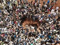 A picture taken with a drone on June 9, 2019 shows Syrians attending the burial of late rebel fighter Abdel-Basset al-Sarout in al-Dana in Syria's jihadist-controlled Idlib region, near the border with Turkey. OMAR HAJ KADOUR / AFP