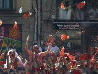 Revellers celebrate during the 'Chupinazo' (start rocket) to mark the kickoff at noon sharp of the San Fermin Festival, in front of the Town Hall of Pamplona, northern Spain, on July 6, 2019.  ANDER GILLENEA / AFP
