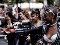 People parade during the Tropical Carnival on July, 7 2019 in Paris.  Kenzo TRIBOUILLARD / AFP