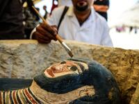 A man brushes off dust from a sarcophagus, part of a new discovery carried out almost 300 meters south of King Amenemhat II’s pyramid at Dahshur necropolis, exposed near the Bent Pyramid. Mohamed el-Shahed / AFP
