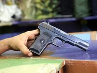 A Soviet-produced TT-33 pistol is pictured at a shop in Yemen's third city of Taez, on July 13, 2019. Before the war, the old market of Taez was crowded with people and full of handcrafts and artisanal goods. Today, more than four years after the Huthi rebels began their siege on Yemen's third largest city, bullets and guns have taken over the market. AHMAD AL-BASHA / AFP