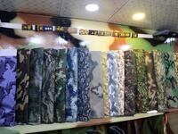 A picture shows military camouflage textiles on display at a shop in Yemen's third city of Taez, on July 13, 2019. AHMAD AL-BASHA / AFP