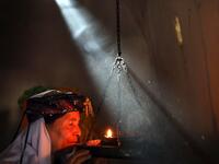 An Iraqi Yazidi woman prays at the Temple of Lalish, in a valley near the Kurdish city of Dohuk about 430km northwest of the capital Baghdad, on July 16, 2019. SAFIN HAMED / AFP