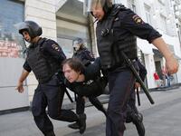Police officers detain a protester during an unauthorised rally demanding independent and opposition candidates be allowed to run for office in local election in September, in downtown Moscow on July 27, 2019.  Maxim ZMEYEV / AFP