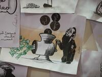 This picture taken on June 16, 2019, shows various illustrations by Syrian Cartoonist Amani al-Ali at her home studio in the city of Idlib in the eponymous northwestern province.  Omar HAJ KADOUR / AFP