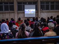 Children attend a film screening as part of the mobile cinema "Komina Film" initiative organised by Syrian-Kurdish filmmaker Shero Hinde, at a school yard in the village of Shaghir Bazar, 55 kilometres southest of Qamishli in the Kurdish-populated areas of northeastern Syria's Hasakeh province, on July 28, 2019.  DELIL SOULEIMAN / AFP