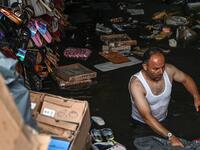 A shop owner tries to save his belongings in a flooded undergate shop center on August 17, 2019 in Eminonu district in Istanbul, after a heavy rainfall. Ozan KOSE / AFP