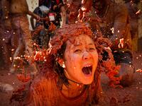 A reveller covered in tomato pulp participates in the annual "Tomatina" festival in the eastern town of Bunol, on August 28, 2019. JAIME REINA / AFP