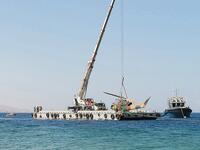 Off the coast of Aqaba, a floating crane manoeuvres into position to build Jordan’s latest tourist attraction: an underwater museum of military vehicles, located on top of a coral reef. (AFP)