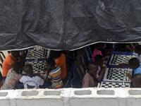 They are thinking about the next move they will make, as part of a project that is supposed to bring hope to a slum in Nigeria's megapolis.  PIUS UTOMI EKPEI / AFP