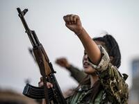 A member of the Bethnahrin Women Protection Forces (HSNB), an all-female Syriac-Assyrian paramilitary group under the umbrella of the Syrian Democratic Forces (SDF), chants slogans as during a commemoration of the fourth anniversary of their creation, in the countryside of the town of Tall Tamr in the northwestern Syrian province of Hasakah, on August 30, 2019.  Delil SOULEIMAN / AFP