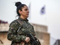 A member of the Bethnahrin Women Protection Forces (HSNB), an all-female Syriac-Assyrian paramilitary group under the umbrella of the Syrian Democratic Forces (SDF), lines up as the group commemorates the fourth anniversary of its creation, in the countryside of the town of Tall Tamr in the northwestern Syrian province of Hasakah, on August 30, 2019.  Delil SOULEIMAN / AFP
