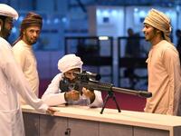 A visitor inspects a sniper rifle during the Abu Dhabi International Hunting and Equestrian exhibition (ADIHEX) in the UAE capital Abu Dhabi on August 31, 2019.  KARIM SAHIB / AFP