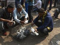 In this photograph taken on December 2, 2018, customers check pigeons at a market in the old quarters of New Delhi. Pigeon flying, locally known as Kabootar Bazi, is a popular hobby among people living in the old quarters of the capital city. Sajjad HUSSAIN / AFP