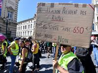 A protester holds a placard reading "Mr Macron President of rich people. Can we live with 650 euros per month ? No" during an anti-government demonstration called by the "Yellow Vests" (Gilets Jaunes) movement on September 7, 2019 in Montpellier, southern France. Pascal GUYOT / AFP