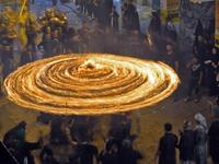 Iraqi Shiite Muslims perform mourning rituals during a ceremony marking the 7th day of Muharram as part of Ashura in the Iraqi holy city of Najaf. Ashura, one of the holiest days in Shiite Islam, commemorates the seventh century killing of Prophet Mohammed's grandson Imam Hussein. Haidar HAMDANI / AFP