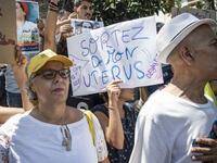 A demonstrator holds up a sign reading in French "get out of my uterus", during a protest outside a courthouse holding the trial of Hajar Raissouni, a Moroccan journalist of the daily newspaper Akhbar El-Youm, on charges of abortion, in the capital Rabat on September 9, 2019. FADEL SENNA / AFP