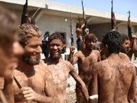 Syrian Turkish-backed fighters from al-Mutasim Brigade react after finishing their training at a camp near the town of Marea in Syria's northern Aleppo district, on September 12, 2019. Nazeer Al-khatib / AFP