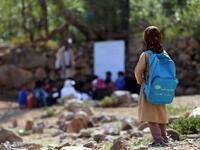Yemeni school children attend an open-air class under a tree near their unfinished school  Ahmad AL-BASHA / AFP