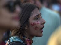 A youth shouts slogans as she sits during a climate strike to protest against governmental inaction towards climate breakdown and environmental pollution, part of demonstrations being held worldwide in a movement dubbed "Fridays for Future", in Islamabad on September 20, 2019. AAMIR QURESHI / AFP