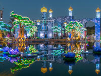 Lake with flowers and castle. Newly opened Dubai Glow Garden day to night transition timelapse is a state of Art architecture featuring environment friendly architecture, creating various structures. (Shutterstock/ File Photo)