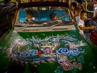 Children play in a car parked next to a Chinese shrine during the annual Vegetarian Festival in Phuket on October 2, 2019. Mladen ANTONOV / AFP