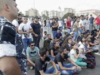 Lebanese protesters try to block a road during a demonstration near central Beirut's Martyr Square on October 6, 2019. Lebanese protested in the capital over increasingly difficult living conditions, amid fears of a dollar shortage and possible price hikes. ANWAR AMRO / AFP