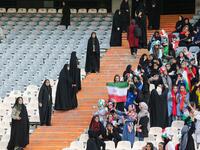 Iranian women cheer and wave their country's national flags as they attend the World Cup Qatar 2022 Group C qualification football match between Iran and Cambodia at the Azadi stadium in the capital Tehran on October 10, 2019. ATTA KENARE / AFP