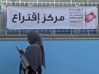 A Tunisian voter waits outside a polling station in the capital Tunis on October 13, 2019 during the second round of the presidential election. Tunisians began voting today in a presidential runoff pitting conservative law professor Kais Saied against media magnate Nabil Karoui, who was released from prison just days earlier. Fethi Belaid / AFP