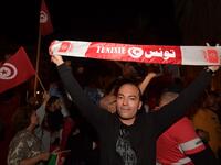 Tunisians gather to celebrate the victory of Kais Saied in the Tunisia's presidential runoff on October 13, 2019, in the capital Tunis. Conservative academic Kais Saied, a political outsider, won a landslide victory Sunday in Tunisia's presidential runoff, sweeping aside his rival, media magnate Nabil Karoui, state television said. Fethi Belaid / AFP