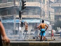 Lebanese demonstrators break traffic lights amidst ongoing protests against dire economic conditions in the northern coastal city of Tripoli on October 18, 2019. Ibrahim CHALHOUB / AFP