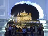 Indian Sikh devotees pay their respects on the eve of "Bandi Chhor Divas" or "Diwali" at the illuminated Golden Temple, in Amritsar on October 26, 2019. Sikhs celebrate 'Bandi Chhor Divas', also on the same day as the Hindu festival of Diwali, to mark the historic return of the sixth Guru, Guru Hargobind NARINDER NANU / AFP