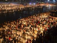 Hindu devotees light earthen lamps on the banks of the River Sarayu on the eve of "Diwali" festival during an event organised by the Uttar Pradesh government, in Ayodhya on October 26, 2019. "Diwali", the Festival of Lights, marks victory over evil and commemorates the time when Hindu god Lord Rama achieved victory over Ravana and returned to his kingdom Ayodhya. SANJAY KANOJIA / AFP