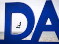 A picture taken on October 10, 2019, shows a kitesurfer performing a jump at Dakhla beach in Morocco-administered Western Sahara. In the heart of disputed Western Sahara, a former garrison town has become an unlikely tourist magnet after kitesurfers discovered the windswept desert coast on the Atlantic is perfect for their sport. FADEL SENNA / AFP