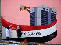 Iraqi demonstrators rest in front of a mural painting in Tahrir square during ongoing anti-government demonstrations in the capital Baghdad on November 2, 2019. The demonstrations have evolved since October 1 from rage over corruption and unemployment to demands for a total government overhaul, shunning both politicians and religious figures along the way. SABAH ARAR / AFP