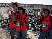 Women take part in the desert trek "Rose Trip Maroc", on November 3, 2019 in the erg Chebbi near Merzouga. The Rose Trip Maroc is a female-oriented trek where teams of three must travel through the southern Moroccan Sahara desert with a compass, a map and a topographical reporter. JEAN-PHILIPPE KSIAZEK / AFP