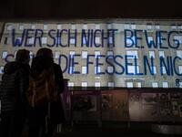A giant banner reading: "He who does not move can not feel his restraints" is projected on the walls of the former Stasi (Former east German secret police) headquarters during the city-wide kick-off of the festival week to celebrate the 30th anniversary of the November 9,1989 fall of the Berlin Wall, in Berlin on November 4, 2019. Germany marks three decades since the fall of the Berlin Wall this week with main celebrations on November 9, 2019. John MACDOUGALL / AFP