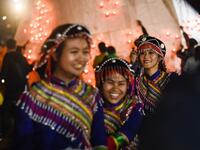 This picture taken on November 4, 2019 shows Wa ethnic women smiling during the Tazaungdaing Lighting Festival at Taunggyi in Myanmar's northeastern Shan State. Brightly coloured balloons with hundreds of homemade fireworks woven into their frames are sent soaring into the night sky, showering down cascades of sparks onto adoring crowds in the annual Taunggyi fire balloon festival. Ye Aung THU / AFP