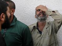 Palestinian men mourn outside the mortuary of Gaza City's Al-Shifa hospital on November 13, 2019, after two more Palestinians were killed in the morning in an Israeli strike, according to Gaza's health ministry, as Israel said it was targeting rocket-launching squads and militant sites. The deaths brought the Gaza toll to 18 people killed since an exchange of fire began on November 12 with an Israeli targeted strike on an Islamic Jihad commander sparking retaliatory rocket launches  ANAS BABA / AFP